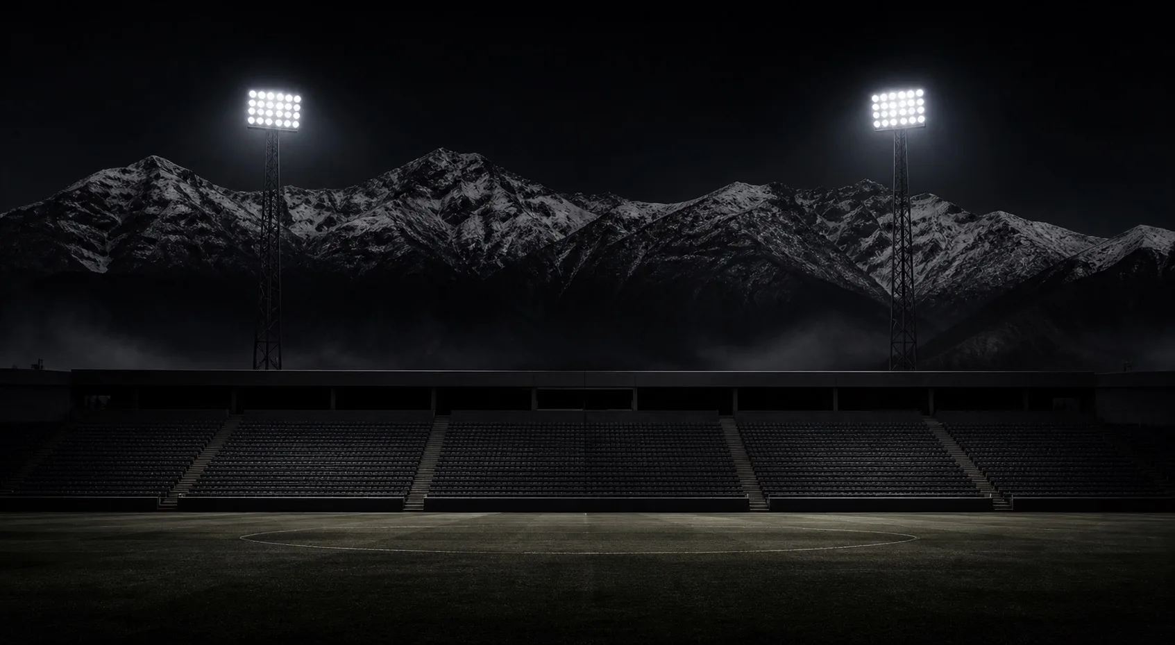 Estadio nocturno con cordillera de fondo